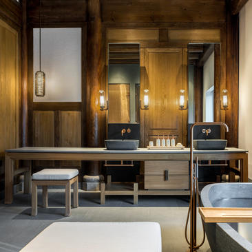 Antique villa bathroom at Amanyangyun with dual vanities, warm wooden finishes and traditional design details.
