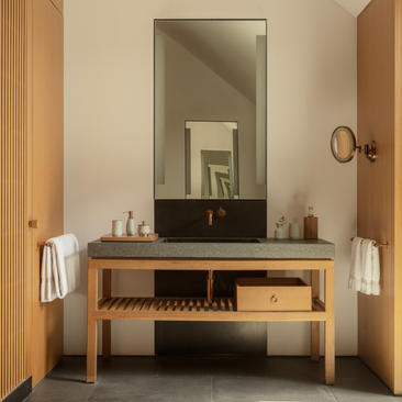 Ming Pavilion bathroom at Amanyangyun with wooden vanity, rectangular mirror and neutral tones.