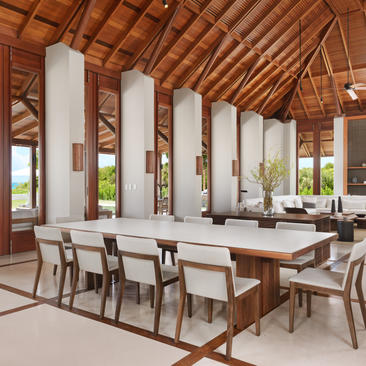 Five-bedroom beach sala villa dining area at Amanyara, Turks and Caicos, with wooden ceiling and stone columns.