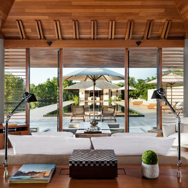 Serenity Villa at Amanyara with wooden pergola framing the view towards the pool and turquoise waters beyond.