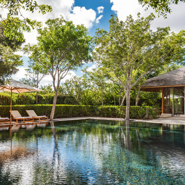Serenity Villa pool and pavilion surrounded by tropical trees at Amanyara, Turks and Caicos.