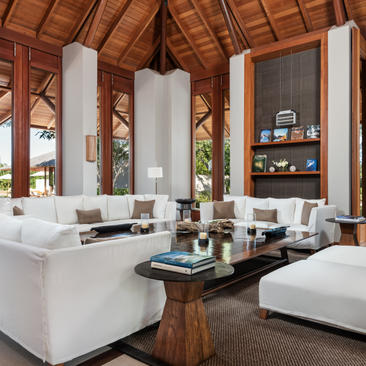 Five-bedroom serenity villa living area with white furnishings and wooden ceiling at Amanyara, Turks and Caicos.