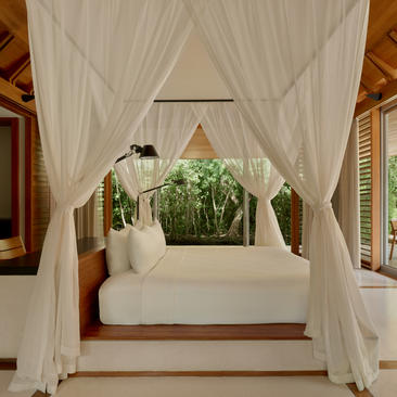 Ocean Pavilion with flowing white curtains framing a daybed at Amanyara, Turks and Caicos.
