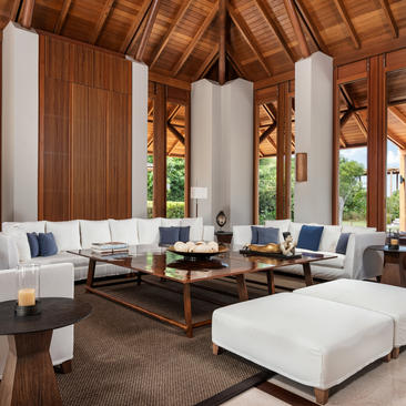 Six-bedroom beach sala villa at Amanyara, Turks and Caicos, with wooden ceiling, central fireplace, and ocean views.