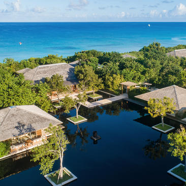 Six-bedroom beach sala villa at Amanyara overlooking turquoise waters and tropical vegetation in Turks and Caicos.