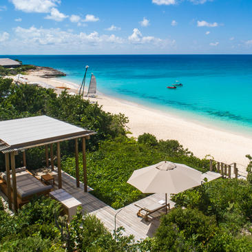 Six-bedroom beach sala villa with covered pavilion overlooking turquoise waters and white sand beach at Amanyara, Turks and Caicos.