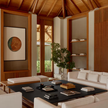 Three-bedroom villa living area at Amanyara with wooden architectural details and modern furnishings.