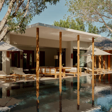 Two-bedroom pool villa at Amanyara with wooden pergola overlooking turquoise water, Turks and Caicos.