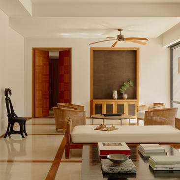 Two-bedroom pool villa living area at Amanyara, with wooden furnishings and open-plan design.