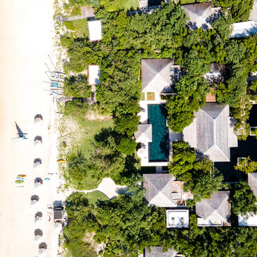Aerial view of bedroom 4 at six-bedroom Amanyara villa, surrounded by lush vegetation and beach access.