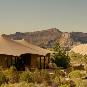 Canvas tent at Amangiri with desert landscape and rocky mountains beyond.