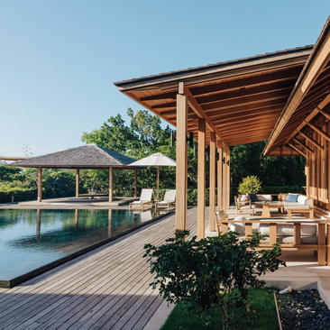 Four-bedroom beach villa with wooden pergola, plunge pool, and sun loungers overlooking Turks and Caicos at Amanyara.