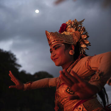 Performer in traditional Balinese dress during a Kecak dance at Amankila resort, Indonesia.