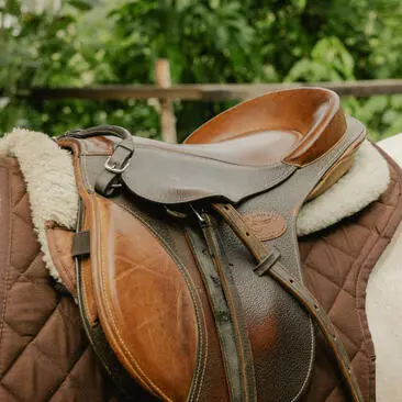 Leather saddle resting on a quilted blanket at Amantaka's horse riding experience.