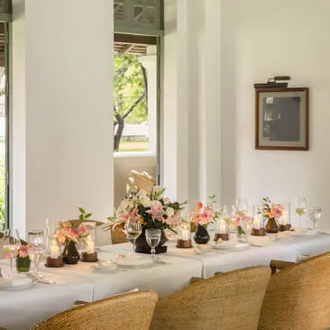 Long table decorated with floral centrepiece at Amantaka, Laos.