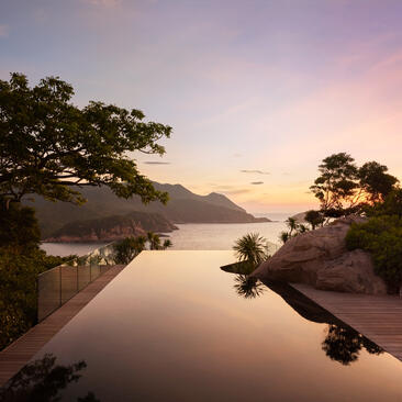 Ocean pool villa overlooking calm waters at Amanoi, Vietnam, at sunrise.