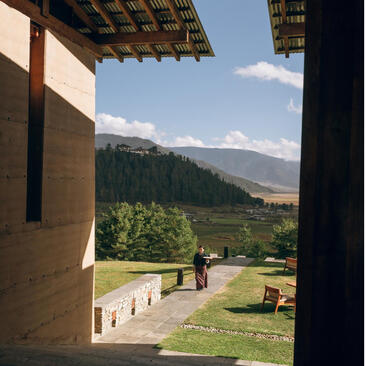 View from Amankora towards Gangtey valley with mountains and forest landscape.