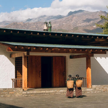 Amankora entrance in Paro with traditional Bhutanese architecture and mountain views beyond.