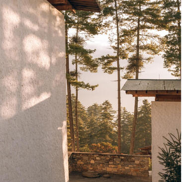 Amankora exterior in Thimphu with modernist architecture and pine forest views.
