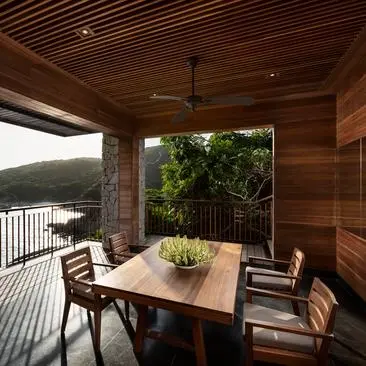 One-bedroom ocean pool residence dining area at Amanoi, with wooden interiors and ocean views across Vietnam's coastline.
