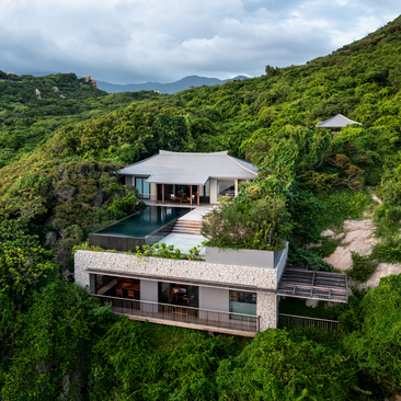 Aerial view of a one-bedroom ocean pool residence at Amanoi, nestled amongst lush Vietnamese hillside vegetation.