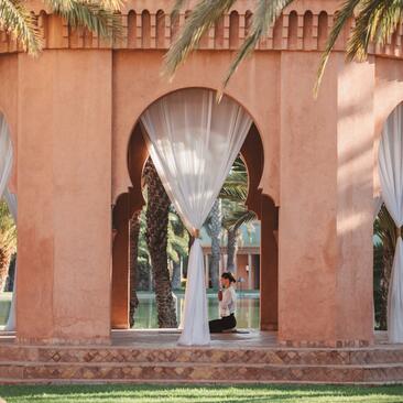 Archway with Moroccan design at Amanjena resort, framing views through to courtyards beyond.