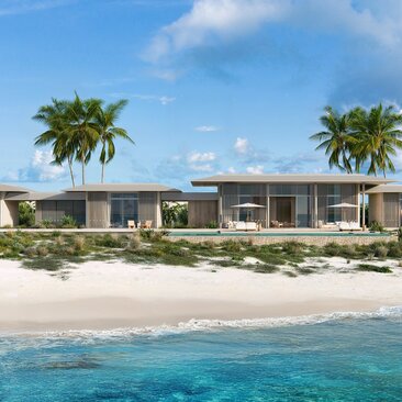 Amancaya villa exterior with whitewashed architecture facing a pristine beach and turquoise waters.