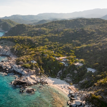 Aerial view of an ocean pool residence at Amanoi, Vietnam, with turquoise waters and forested coastline.