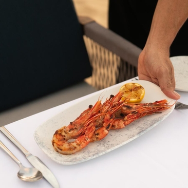 Chef presenting freshly prepared ceviche during a cooking class at Amanera, Dominican Republic.