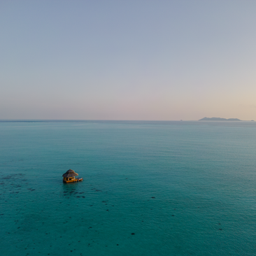 Kawayan Bar aerial view at sunset, Amanpulo resort, Philippines western shore.