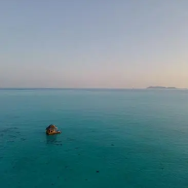 Kawayan Bar seen from above at Amanpulo resort, perched on the western shore above turquoise waters.