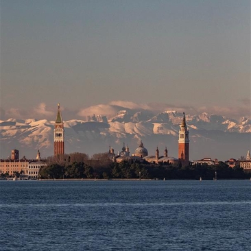 Venice's historic landmarks across the lagoon at dawn, as seen from Aman Rosa Alpina.