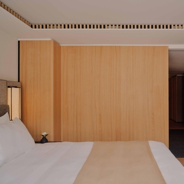 Superior room at Aman Rosa Alpina with wooden wardrobe and bed detail, Italy.