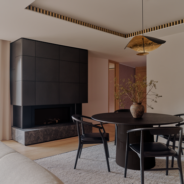 Aman Suite at Aman Rosa Alpina with black fireplace, dining table and contemporary seating in neutral tones.