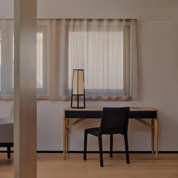 Dolomites Suite with desk, chair, and mountain views at Aman Rosa Alpina resort.