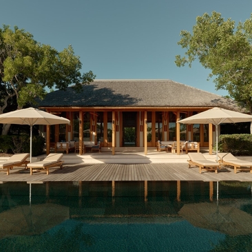 Amanyara villa with thatched roof and wooden pavilions overlooking a turquoise pool in Turks &amp; Caicos.