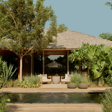 Amanyara villa pavilion with thatched roof, jacuzzi, and tropical vegetation overlooking the Caribbean.