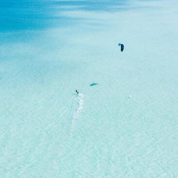 Kitesurfer in the lagoon at Amanpulo resort, Philippines.