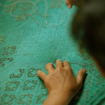 手触及曼谷奈乐安缦酒店的绿松石色织物细节纹样。