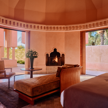 Pool pavilion at Amanjena resort in Morocco, with terracotta walls and curved architecture.