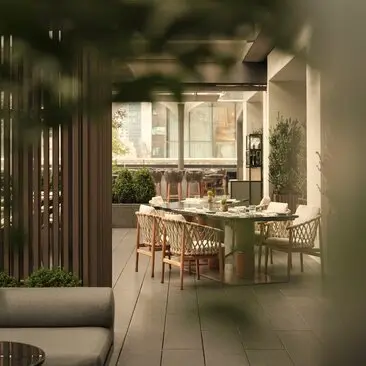 Garden Terrace dining area at Aman New York with wooden furniture and natural light filtering through architectural screens.