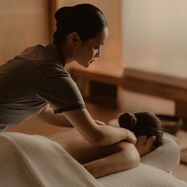 Therapist administering a relaxing massage treatment at Aman Tokyo's spa wellness facility.