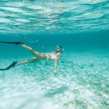 Snorkeller exploring shallow turquoise waters at Amanyara, Turks and Caicos.