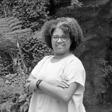 Odete Cruz, staff member at Amanyara, stands with arms crossed in a black and white headshot.