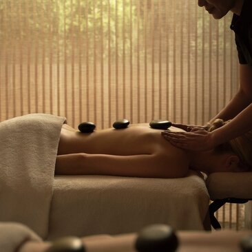 Couple receiving a relaxing massage treatment together in a serene spa room at Aman New York.