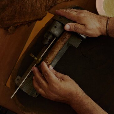 Artisan hands rolling a cigar at Amanera resort, Dominican Republic.