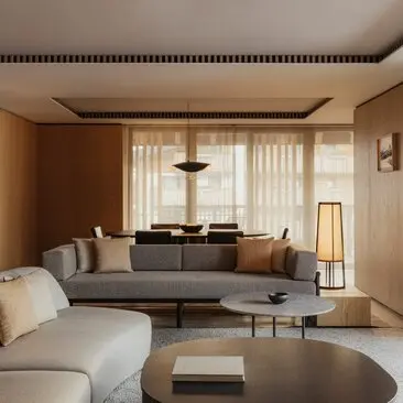 Rosa Alpina Suite sitting area with neutral furnishings and alpine views at Aman Rosa Alpina resort, Italy.