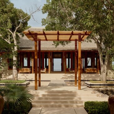 Villa with wooden pergola and manicured gardens at Amanyara, Turks and Caicos.