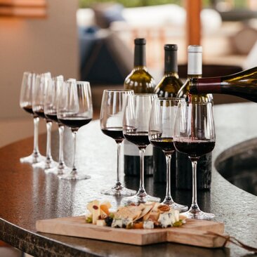 Wine tasting at Amanyara's main bar, Turks and Caicos, with glasses and bottles arranged on counter.