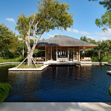 Four-bedroom villa exterior with beach sala pavilion overlooking pond at Amanyara, Turks and Caicos.
